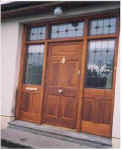 Teak double doors with two side lights and fan light